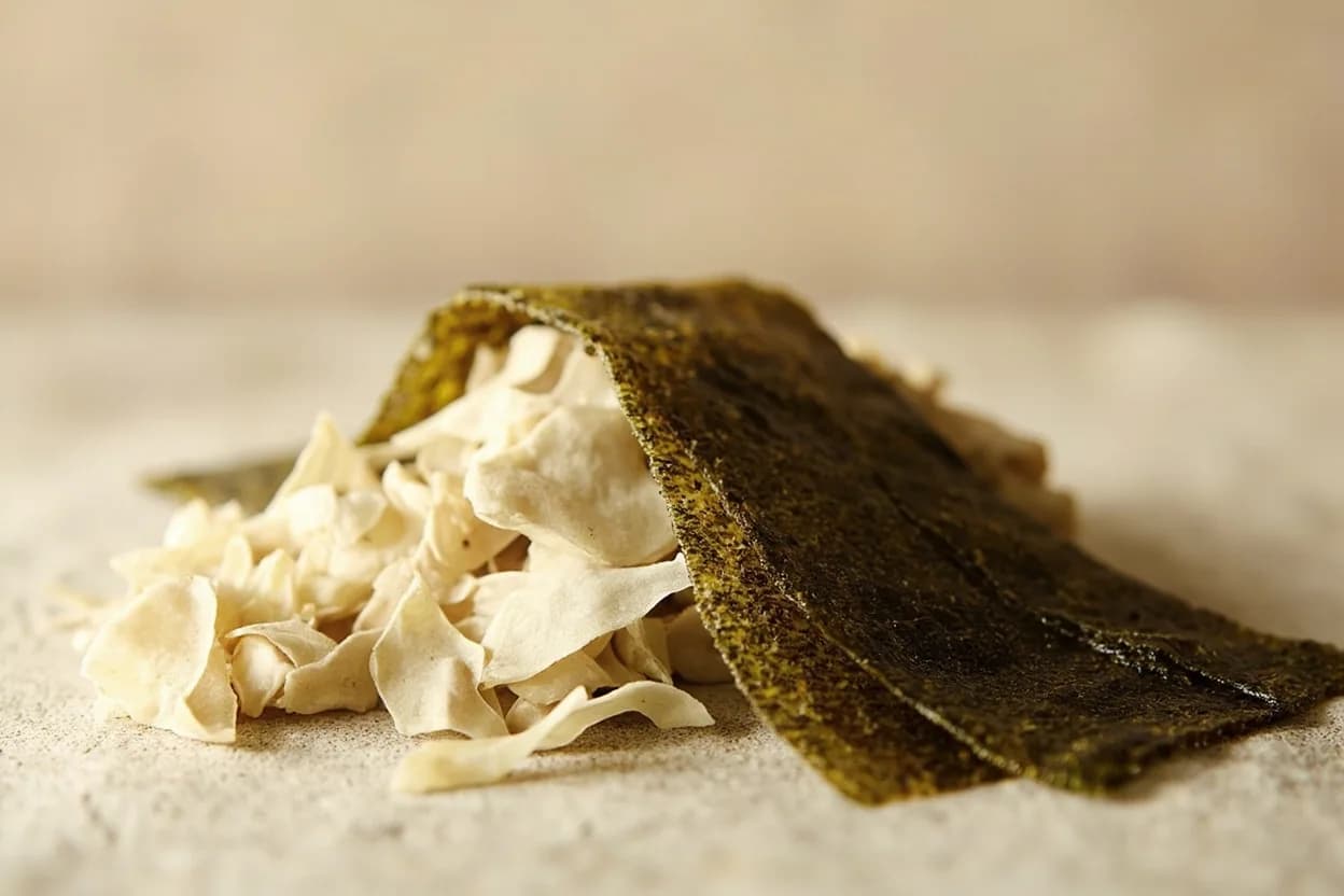 Kombu paired with Katsuobushi (bonito flakes) (Japanese) — the canonical affinity made visible. Kombu and katsuobushi together create ichiban dashi — the glutamate-inosinate synergy amplifies umami to extraordinary levels.