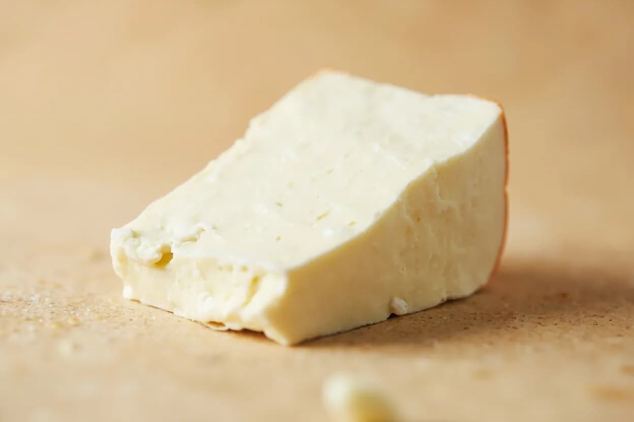 Queso Fresco in its natural form. Queso fresco is an unaged Mexican fresh cheese made from cow's milk (or a cow-goat blend), pressed into rounds and brined lightly. Tasting profile: fresh whole milk, gentle lactic acid, clean brine / light salt, subtle grassy note.