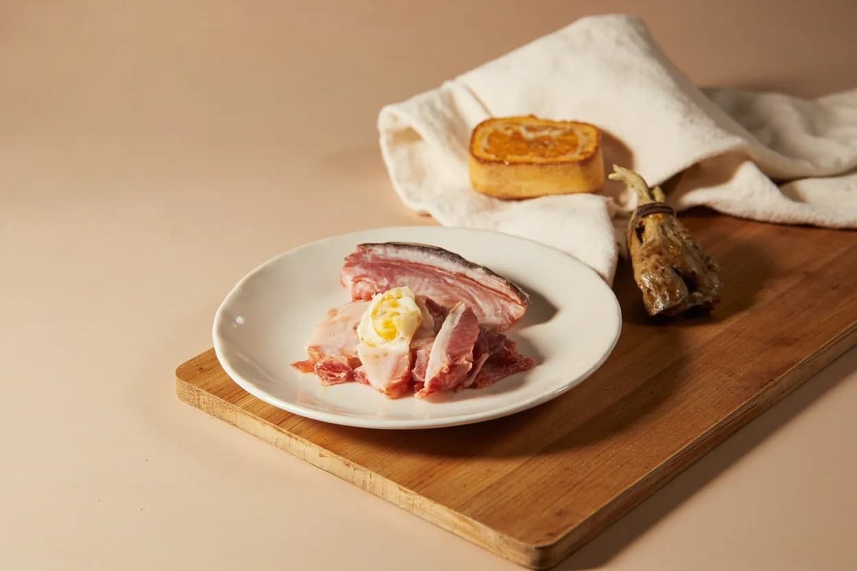Red Mullet (Sultan Ibrahim) Bone-Out Technique in its raw whole-cut form on a butcher's board — Red mullet (Mullus surmuletus and M. Identifying traits: Vivid coral-red to crimson skin — the visual centerpiece of any dish; must not be torn, Intensely flavored dark liver (foie de rouget) sometimes cooked inside the fish or spread on croutons, Pin bones set at an oblique 30–40° angle, running from head end toward tail — must be pulled toward the head.