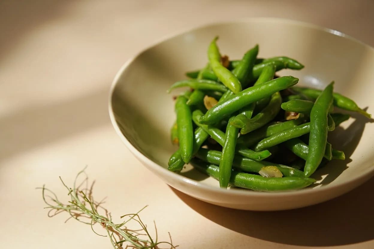 Vegetable Blanch Timing by Type in practice — Salad Niçoise (blanched green beans, haricots verts). Heavily salted water (10–15 g per litre) seasons from the outside in during the brief blanch and also raises the boiling point fractionally, giving marginally more energy at the surface.