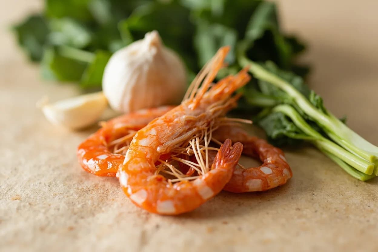 Dried Shrimp paired with Garlic and shallot (Malaysian, Indonesian, Singaporean, Chinese) — the canonical affinity made visible. The South and Southeast Asian starting point: dried shrimp sautéed with minced garlic and shallot in oil creates a fragrant, powerfully savory base for any stir-fry or braise.